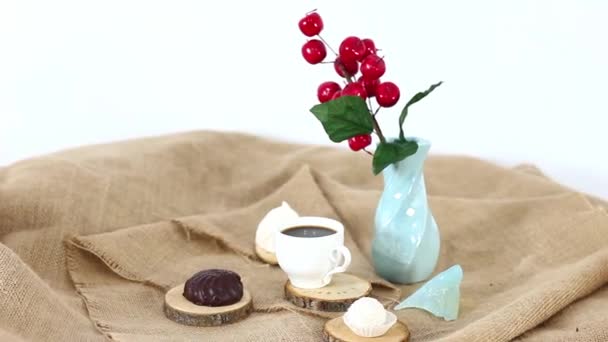 vase with cherries with black coffee cup with marshmallows on spinning table background