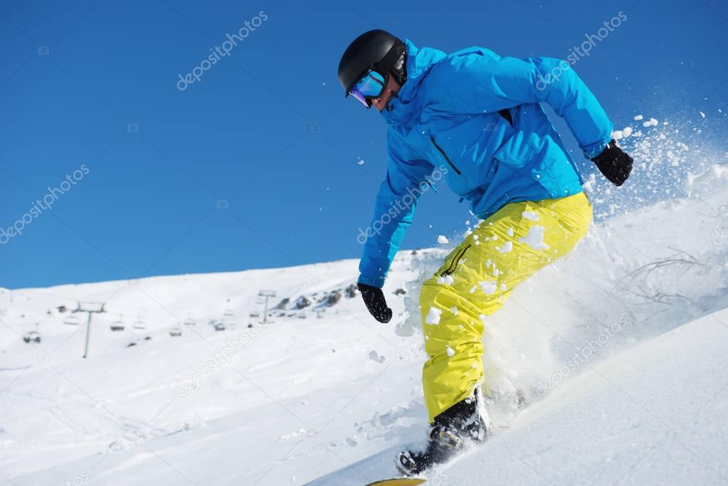 Snowboarder riding down