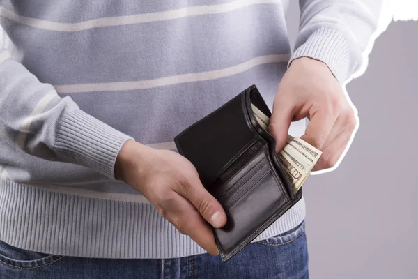 man holding a wallet with money