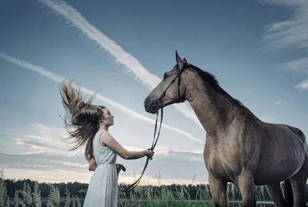 Blond young woman playing with a majestic stallion — Stock Photo, Image