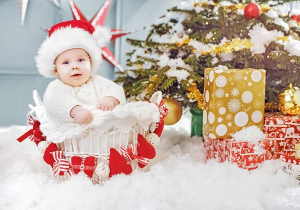 Cute little santa sitting in the wicker basket — Stock Photo, Image