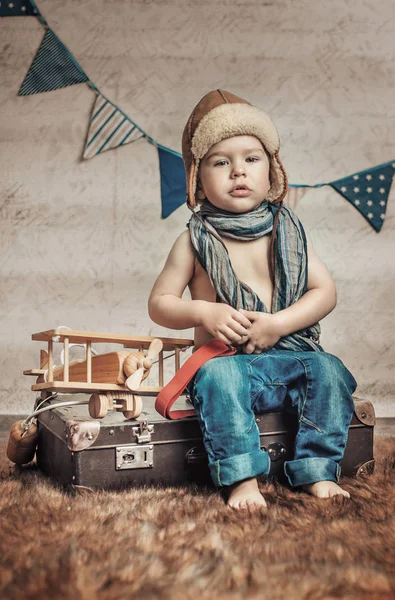 Small, cute pilot with a wooden plane Stock Photo