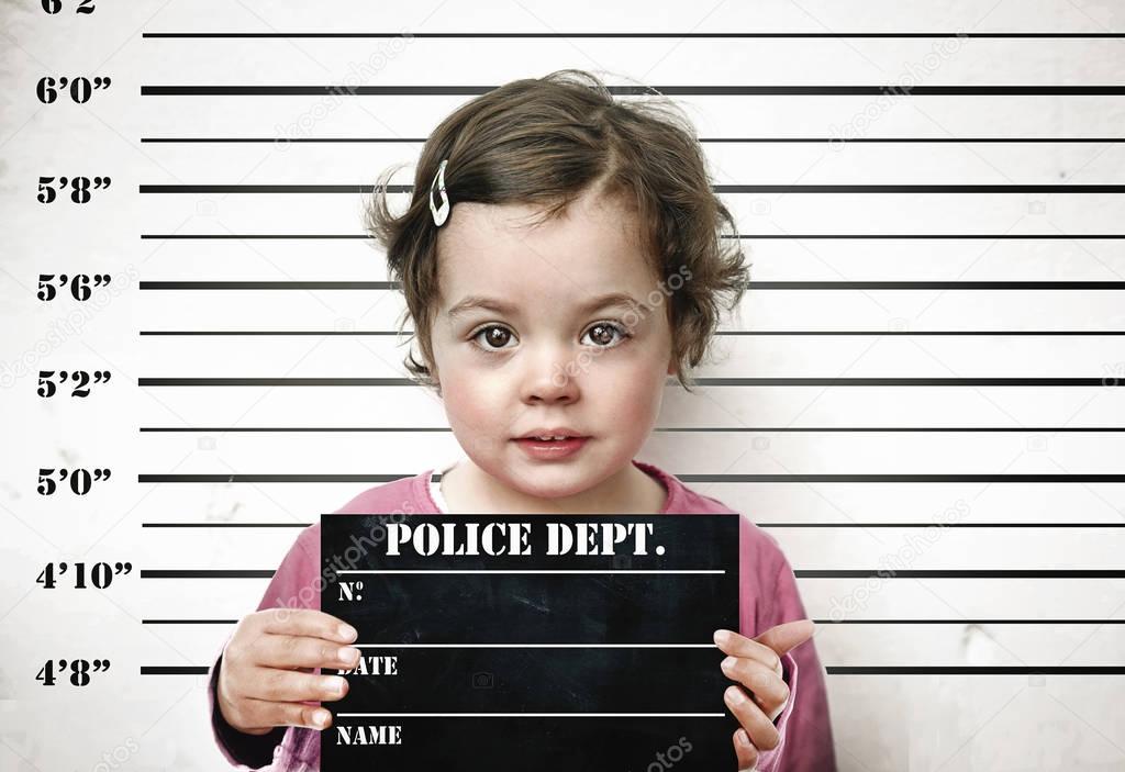 Little child posing with a prison board