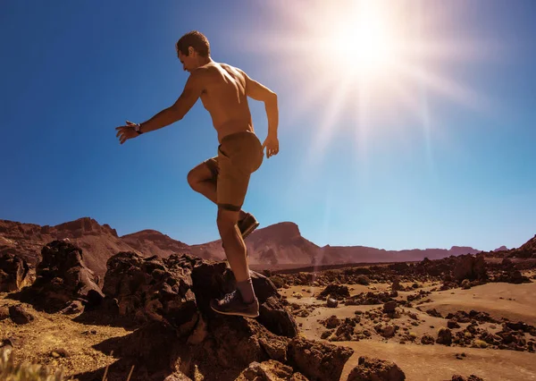 Bonito, homem musculoso correndo no deserto — Fotografia de Stock