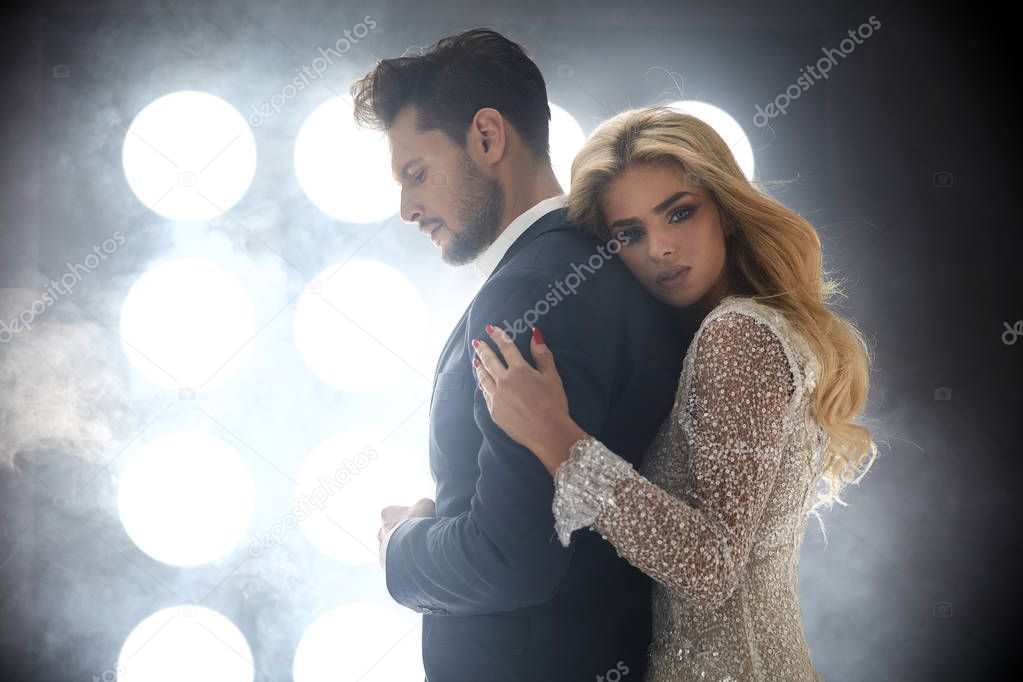 Adorable blond lady hugging a handsome guy