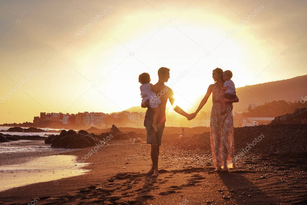 Relaxed family on tropical beach, beautiful sunset