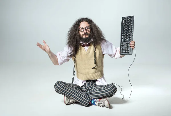Calm Geek Holding Keyboard — стоковое фото