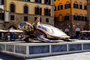 Florence, Italy - 15, June 2015: Monument of the golden turtle near the Palazzo Vecchio.