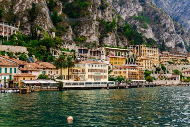 Limone Sul Garda, Brescia / Italy - 24 September 2017: Colorful houses and hotels on the lake shore against the backdrop of mountains.