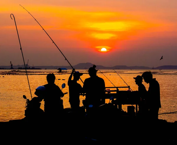 Silueta de pescador en el mar con cielo al atardecer —  Fotos de Stock