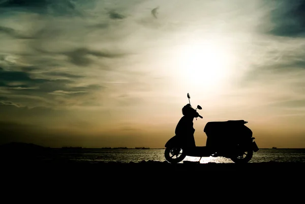 Silhouette scooter at seaside — Stock Photo, Image