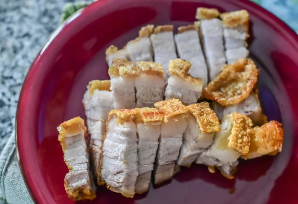 Crispy pork in red dish — Stock Photo, Image