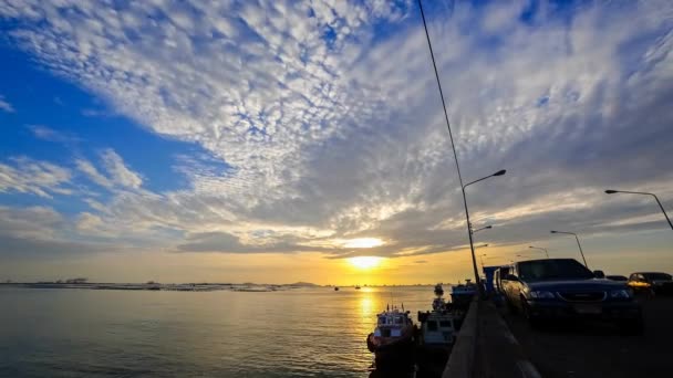 4K Time lapse of sunset sky at sea with port silhouette foreground — Stock Video