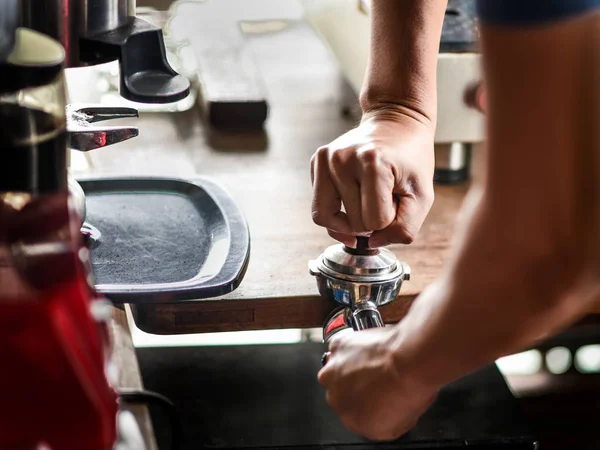 Coffee maker push the coffee powder in the espresso scoop — Stock Photo, Image