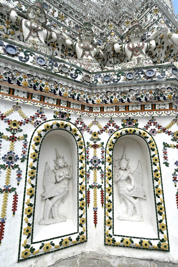 The sculpture of Guardian angle decorate at Prang building in Wat Arun Ratchawararam Ratchawaramahawihan (After big renovate), Bangkok, Thailand 