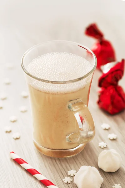 Eggnog in glass cups with a delicate foam, spices and a cinnamon stick — ストック写真