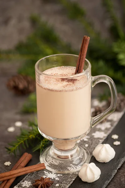 Eggnog in glass cups with a delicate foam, spices and a cinnamon stick — ストック写真