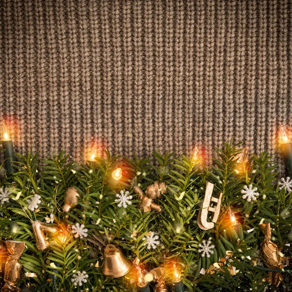 Christmas dark background of a knitted sweater with a garland — Stock Photo, Image