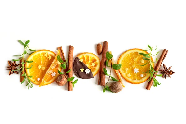 Christmas composition of candied orange peel, cinnamon sticks, nuts, leaves and rosemary — Stock Photo, Image