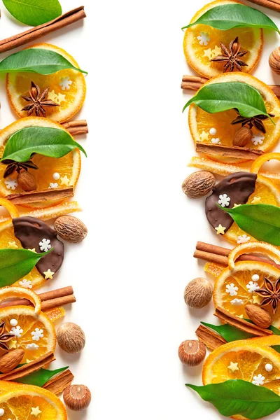 Christmas composition of candied orange peel, cinnamon sticks, nuts, leaves and rosemary — Stock Photo, Image