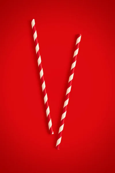 Christmas cocktail straws on a red background — Stock Photo, Image