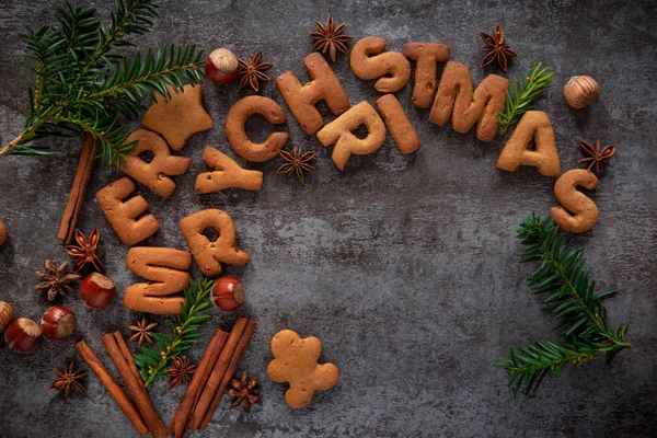 Gingerbread words Merry Christmas on a dark background — Stock Photo, Image