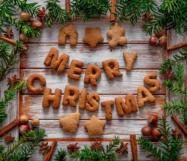 Gingerbread words Merry Christmas on a wooden background — Stockfoto