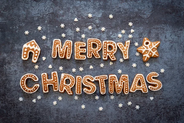 Gingerbread words Merry Christmas on a dark background — Stockfoto