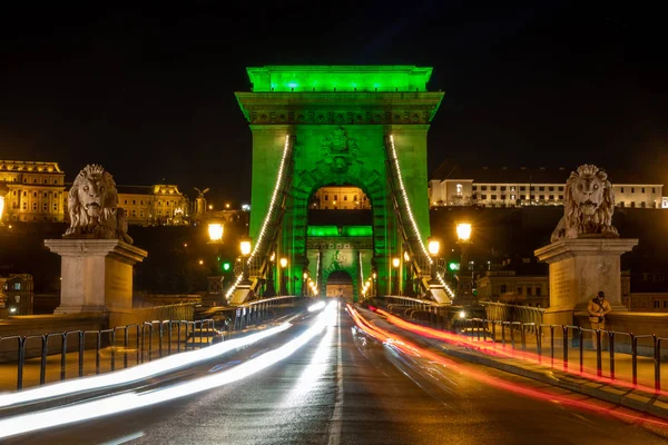 Chain Bridge with green lights on St. Patricks day in Budapest — стокове фото