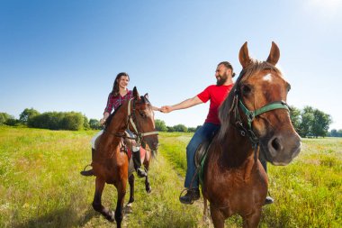 couple riding horses clipart