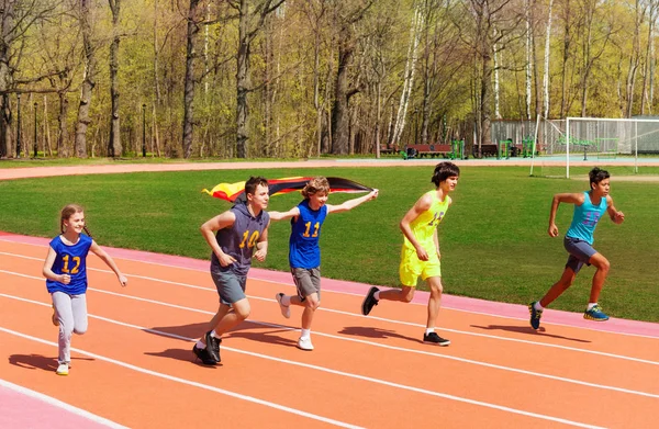 Teenage sprinters with German flag — Stock Photo, Image