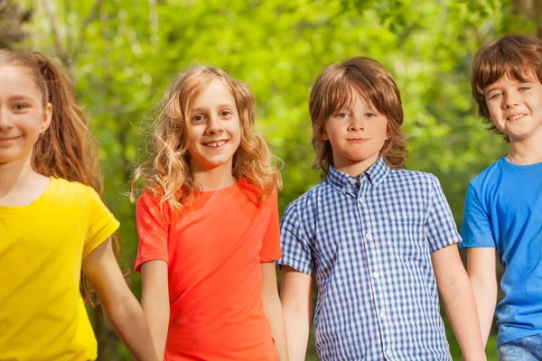 Kids holding hands outdoor — Stock Photo, Image