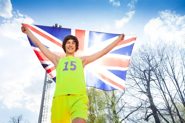 Atleta correndo com bandeira britânica — Fotografia de Stock