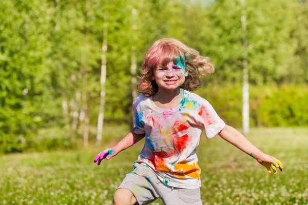 Boy playing with colored powder — Stock Photo, Image