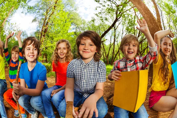 Kids reading book in forest — Stock Photo, Image