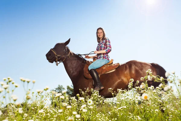 Girl riding bay horse — Stock Photo, Image