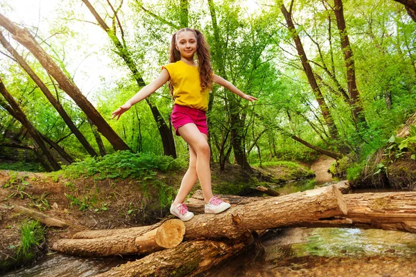 Girl balancing on log — Stock Photo, Image