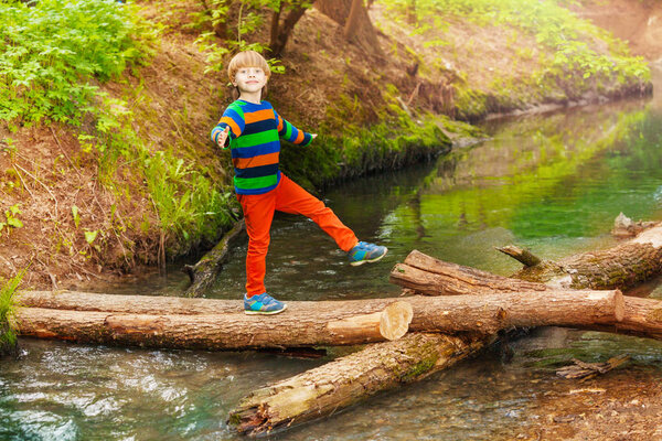 cute boy crossing river