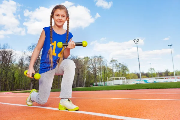 Girl doing exercises with dumbbells — Stock Photo, Image