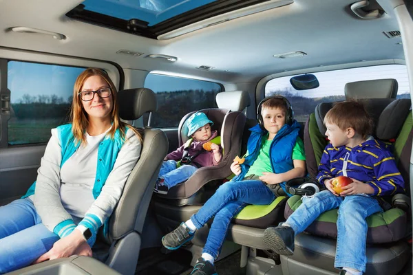 Mère et trois garçons en voiture — Photo