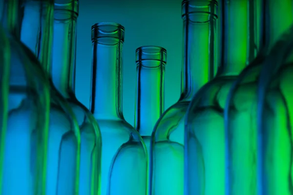 Glass wine bottles on blue — Stock Photo, Image