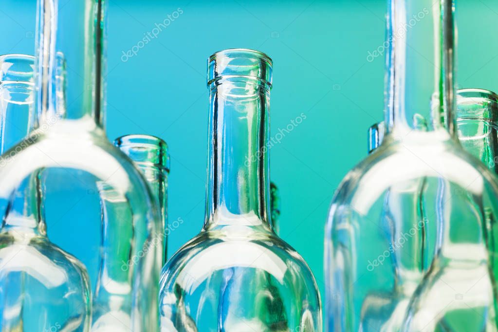 Glass wine bottles on blue