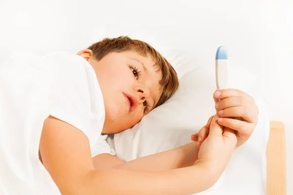 Boy checking thermometer — Stock Photo, Image