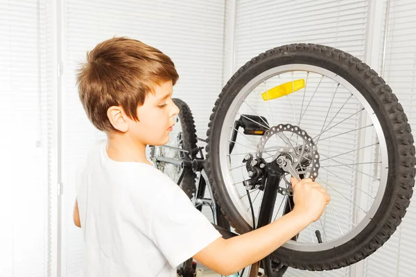 happy boy fixing bicycle