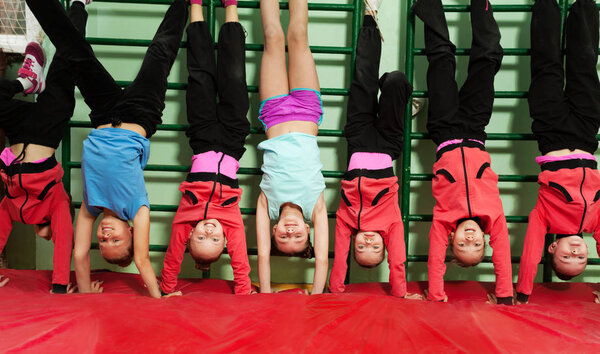 boys and girls making handstand position