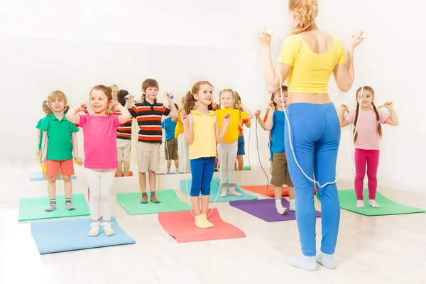 Kinderen met coach met behulp van springen touw — Stockfoto