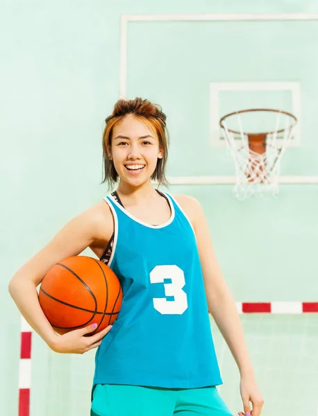 teenage girl holding ball
