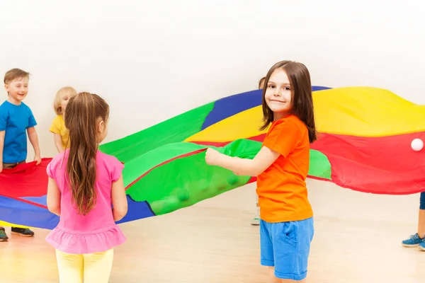 Meisjes en jongens met parachute — Stockfoto