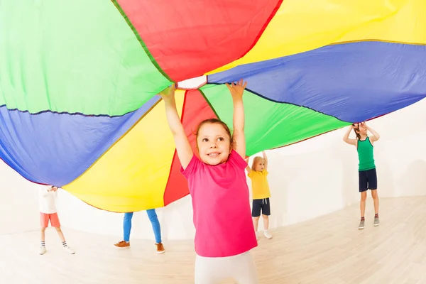 girl under colored parachute