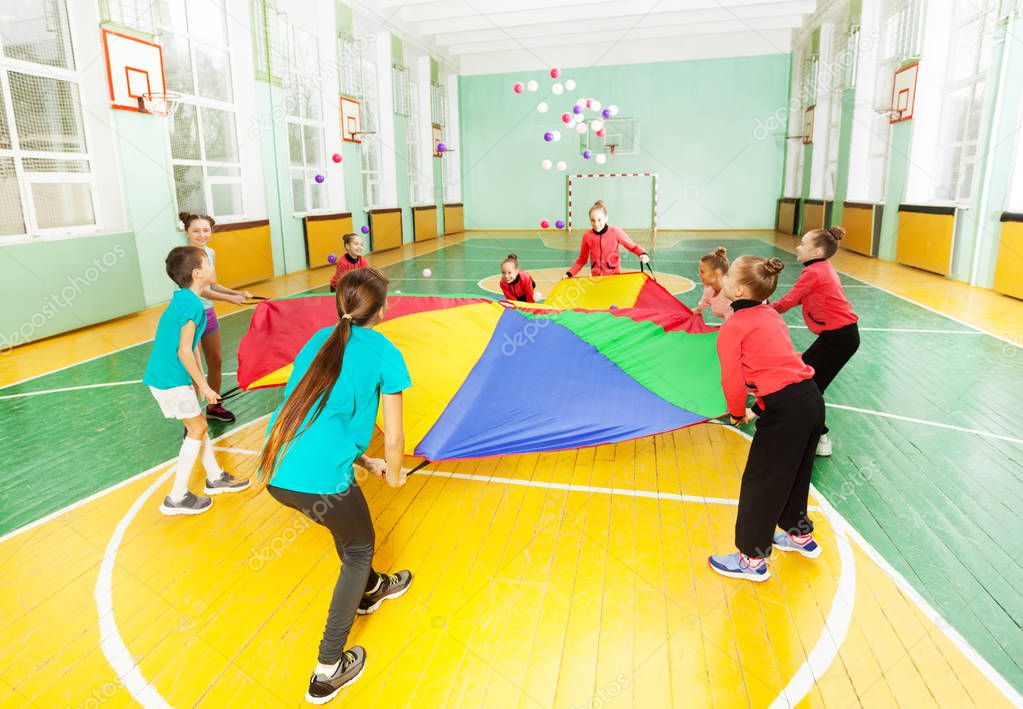 boys and girls playing parachute games